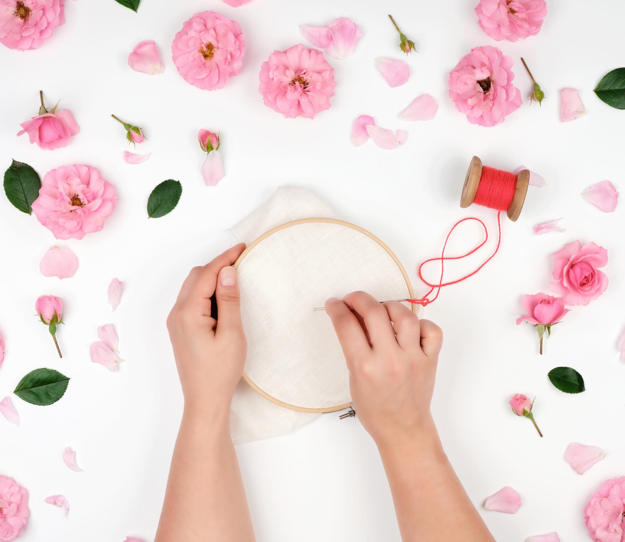 artisan at work stitching a floral pattern